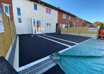 New tarmac driveway with white border lines outside house