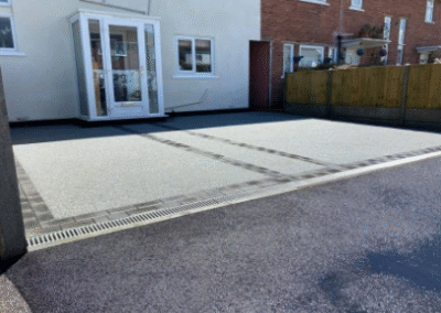 Resin bound driveway with modern edging outside home