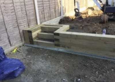 Timber retaining wall and steps under construction in garden