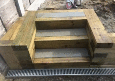 Wooden garden steps with concrete treads and drainage channel