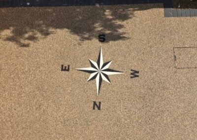 Resin driveway with compass design and brick borders