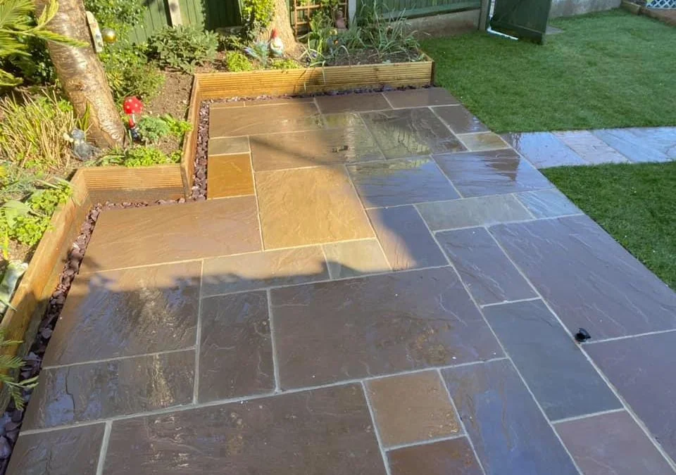 Indian sandstone patio with raised garden beds
